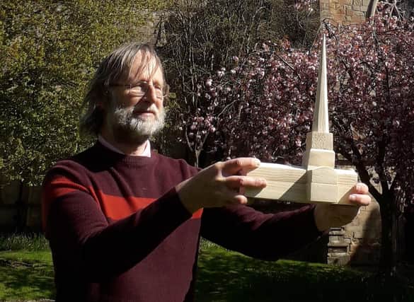 Martin Coslett, co-writer of The Crooked Spire murder-mystery musical, with a model of St Mary's Church, Chesterfield, as it would have looked when the spire was first built. Ashgate Heritage Arts believes it is the only model which depicts the church with a straight spire.