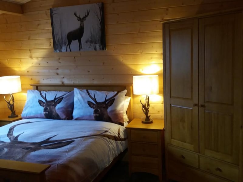 This cute chalet near Airdrie, in North Lanarkshire, has two bedrooms, free wifi, and private parking on site. Lochinvar log cabin with hot tub also has a garden with a barbecue and great hiking routes nearby.