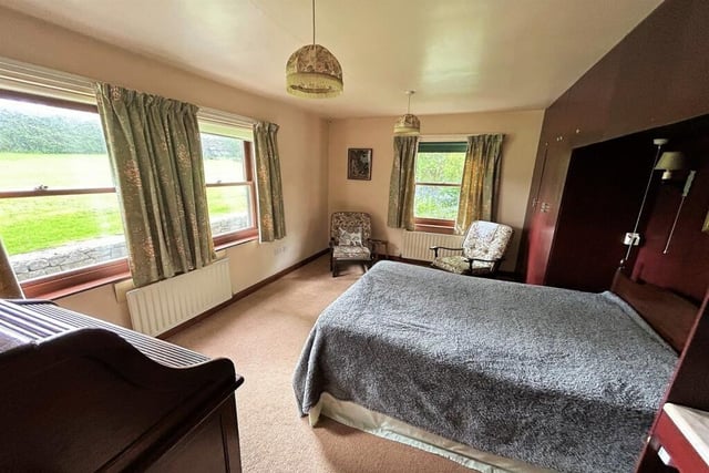 Fitted furniture in this double bedroom which has views over the rear garden.
