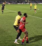 Match winner Daniel Odunaiya (in red) competes for the ball in Alfreton Town's win over Guiseley