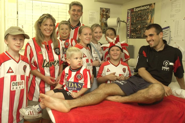 Blades fans in the physio room with player Anthony Tansley .