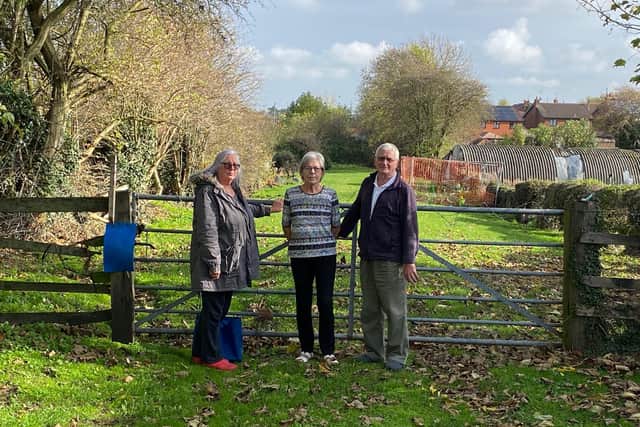 Sharon Gregory, Jenny Blackwell and Eric Blackwell at the entrance to the land at the bottom of Rood Lane.