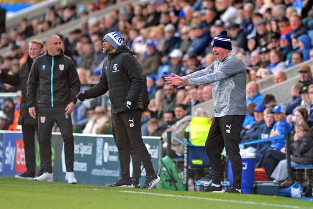 Coaching staff from both sides watch Chesterfield and Tranmere Rovers play out a 1-1 draw.. Pictures by Brian Eyre