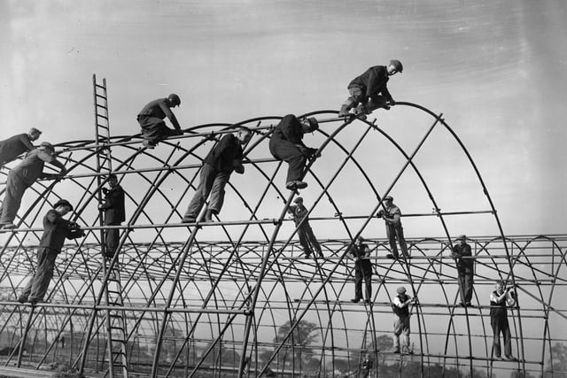Royal Engineers and civilians work together, building the steel frames for Iris huts on a building site in Derbyshire, as part of work to build new towns, almost overnight on October 8, 1942.  (Photo by Keystone/Getty Images)