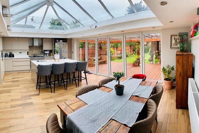 The bi-folding doors open onto the garden creating a "beautiful space for entertaining". The glass roof and double glazed window to the side provide this room lots of natural lighting, there are two radiators and porcelain tiled flooring.