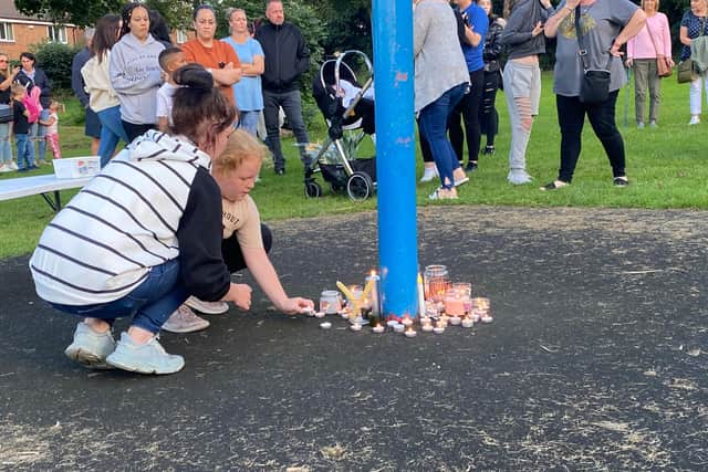 Many took it in turns to place candles during the vigil for the Killamarsh victims on Monday evening