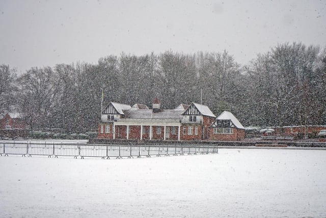 Queen’s Park has been covered in snow - with Chesterfield cricket pavilion ahead in the distance.