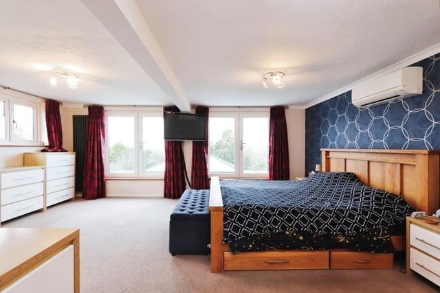 The first floor houses five of the six bedrooms, most notably this marvellous master, which is incredibly spacious and boasts superb views of the back of the £960,000 property. Three of the bedrooms are blessed with air conditioning.
