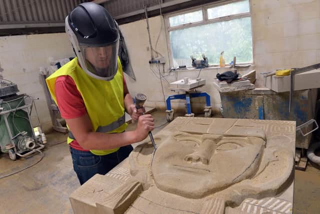 Derbyshire stonemason Stephen Nicholson working on recent commission for a primitive head