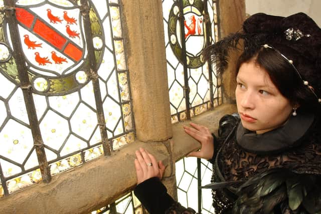 Karen Castelblanco as Mary Queen of Scots peered through the window at Manor Lodge to promote their upcoming Open Day in 2004