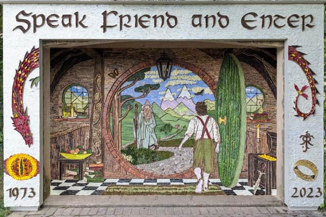 The well dressings at Holymoorside have been created using more than 40 types of flowers, leaves and seeds - as well as  2,500 senecio leaves, each one cut in half, for the  white background.