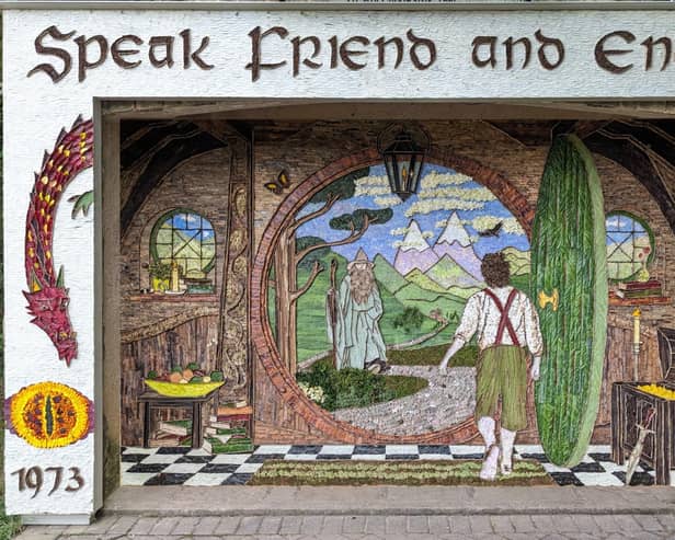 The well dressings at Holymoorside have been created using more than 40 types of flowers, leaves and seeds - as well as  2,500 senecio leaves, each one cut in half, for the  white background.