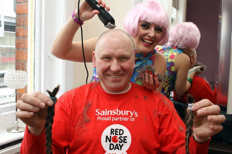 Pete Fessey having his hair cut for comic relief and donating it to a childrens charity. also pictured is Elyssa Crockett, senior Stylist at Mark Roberts salon