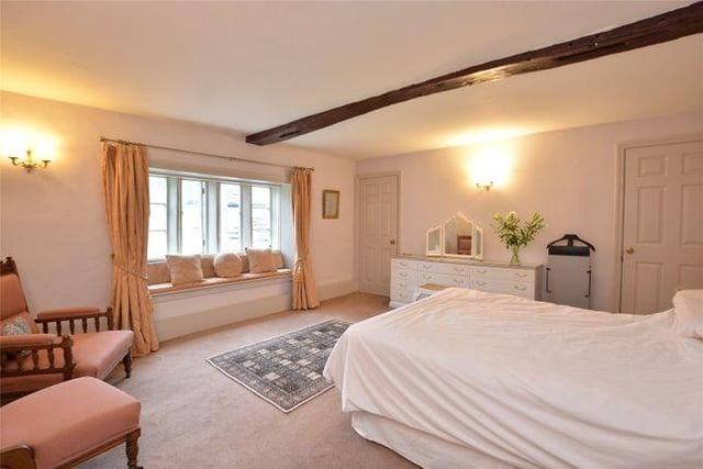 The spacious master bedroom has a dressing room which leads to an en suite bathroom