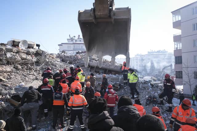 Rescue teams, firemen and volunteers work on a collapsed building to evacuate a victim in Elbistan after earthquakes caused widespread destruction in southern Turkey and northern Syria (photo: Getty Images.Mehmet Kacmaz)