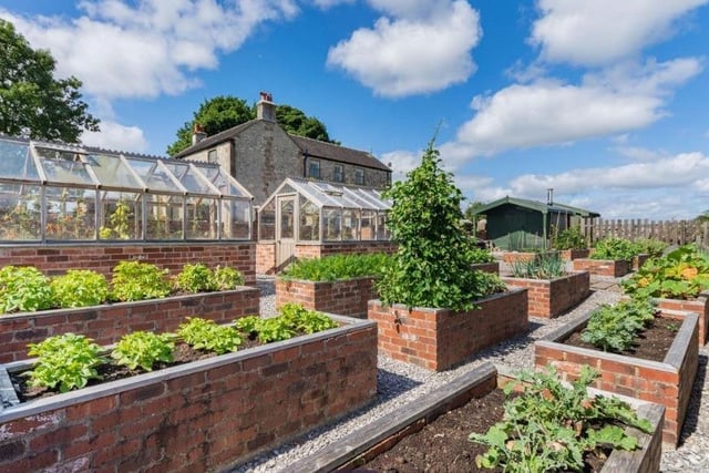 The gardens include raised beds and two glasshouses.