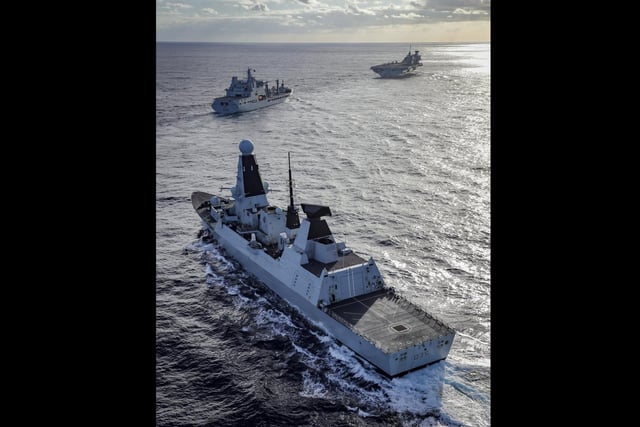 The warships of the UK's carrier strike group assemble. HMS Dragon, RFA Tideforce and HMS Queen Elizabeth sail together. This image won the People's Choice Award. By Leading Photographer Kyle Heller