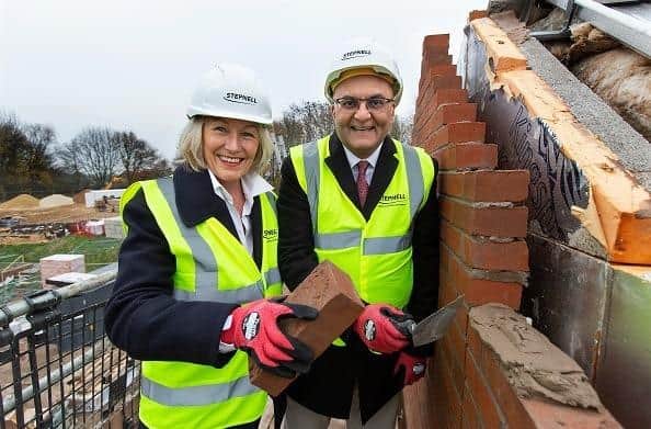 Beverley Webster OBE, Chair of the Health and Wellbeing Hub Steering Group and Atulkumar Patel MBE, Chair of Chesterfield Royal Charity, on the top floor of the scaffolding laying the final brick of Chesterfield Royal Hospital’s Health and Wellbeing Hub.