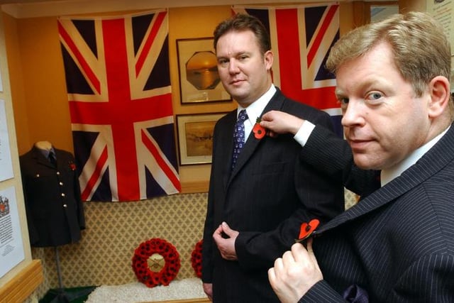 The Co-op Funeral Care's Shaun Varley and Ian Smith setting up a poppy display in 2004.