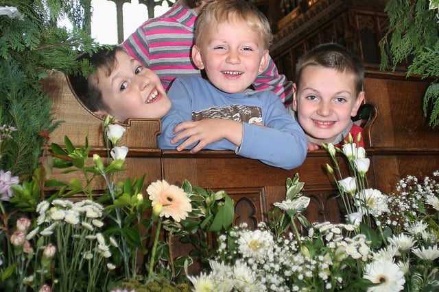 Young helpers at the Tideswell church flower festival in 2009 were Luke, Jacob and Tom Bower and Catherine Slyfield