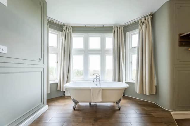 Get your day off to a refreshing start in this elegant rolltop bath which takes pride of place in the master bedroom.