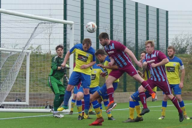 Action from Clowne Comets' (maroon/blue) 9-0 win over Tupton. All photos by Martin Roberts.