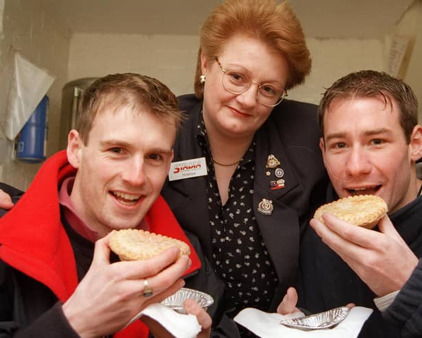 Town players Chris Perkins and Jonathan Howard tuck into Teresa Booth's pies at Saltergate in 1998.