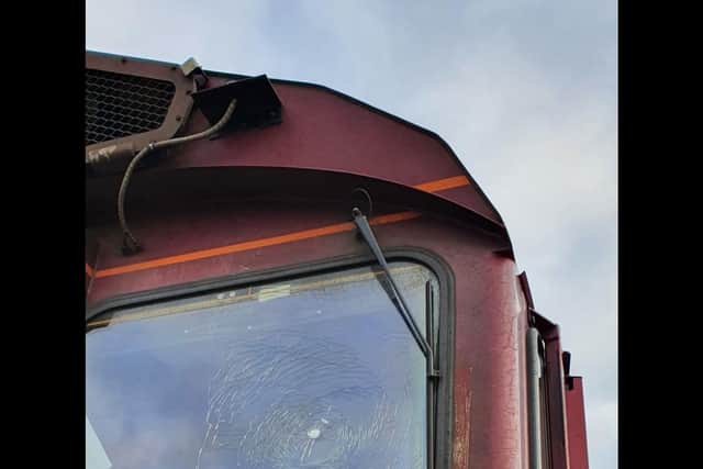 The object was thrown at the freight train and smashed its window