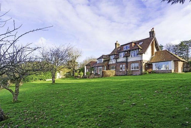 In the front garden there is a small wooded area that leads down to a pond. To the rear, there is a large patio area which leads down to the outdoor heated swimming pool. Further down the garden, there is a woodland area that spans out to reach the boundaries.