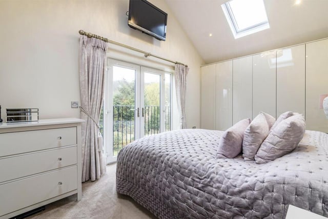 Moving upstairs now to check out the five bedrooms. Here is the master, which has extensive wardrobe space and also access to a Juliet balcony and an en suite shower room.