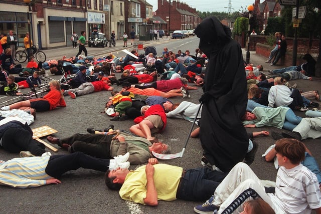 Pictured in Killamarsh, where protestors blocked off the Sheffield Road, and fell to the ground as if dead, when SARP tested its new warning siren, as they lay in the road the grim reaper passed among them. Protestors wanted the SARP site closed.