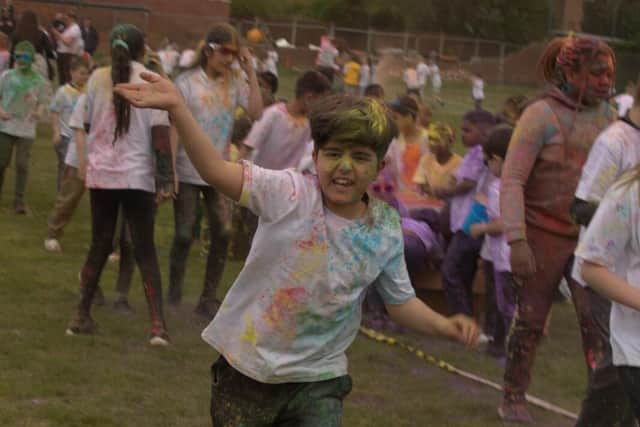 KS2 children celebrating in colour during their sponsored colour run.