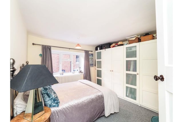 Virtually identical in size to the principal bedroom, this room has a modern radiator and carpeted floor.