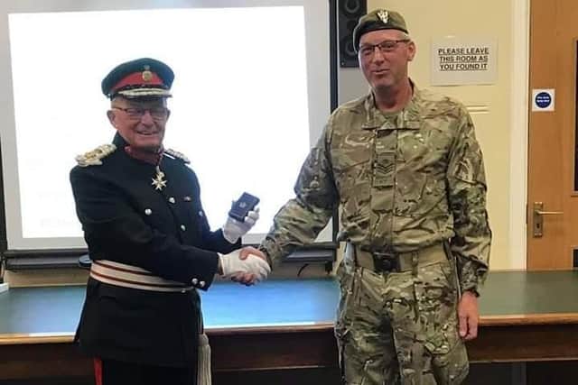 John Allen (right) being presented with a long-service medal for his time in the Army Cadet Force.