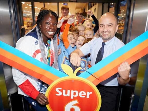 Store manager Keith Blumenstock and Team GB athlete Anyika Onuora officially open the store. Picture submitted.