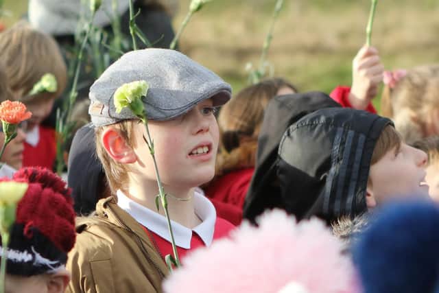 Children from Duckmanton Primary School lay flowers to remember those killed in the 1938 tragedy.
