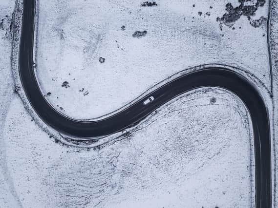 A road winds through snow covered fields near Hope Valley. Photo - SWNS