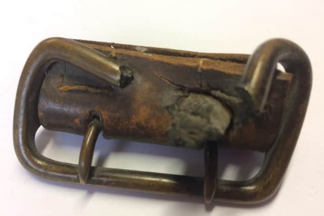 First World War belt buckle with shrapnel embedded.