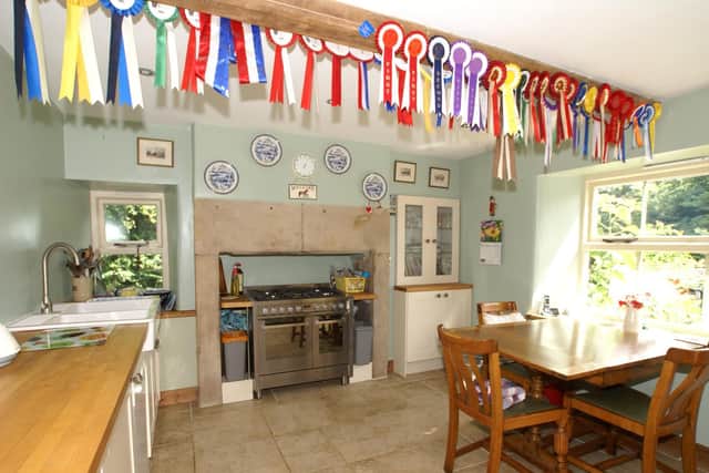 The dining kitchen has Shaker-style units and a range-style cooker.