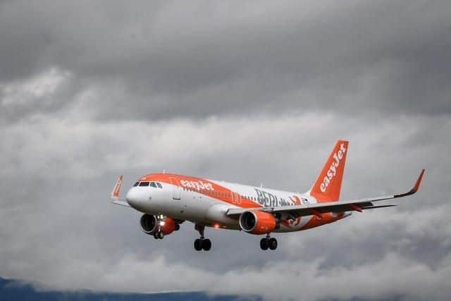 A commercial plane of low-cost carrier EasyJet is seen landing at Geneva Airport (Photo credit should read FABRICE COFFRINI/AFP/Getty Images)