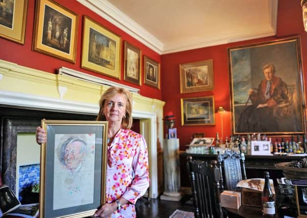 Alexandra Sitwell, with portraits of  Sir Osbert and Sachie Sitwell, who are the focus of the Brothers in Art exhibition at Renishaw Hall.