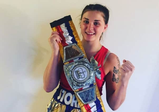 Storm Steele, of the Spire Boxing Academy, shows off her belt after winning the East Midlands middleweight title.