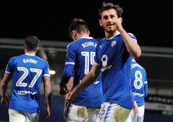 Jak McCourt celebrates with the fans after Spireites' third goal