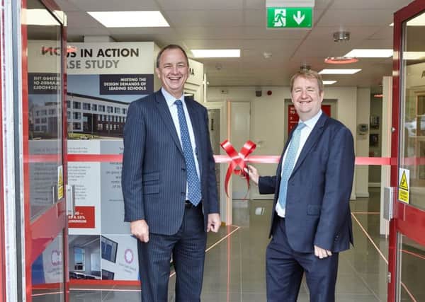 Eurocell chief executive Mark Kelly opens his firm's flagship showroom in Alfreton with Amber Valley, MP Nigel Mills