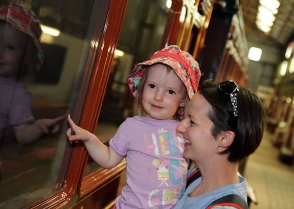 Ripley Big Day Out at Midland Railway.    
Felicity Norton, 22 months and her mum Justine from Ripley, sneak a peak through the carriage windows of the museum.