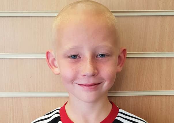 Athan's sponsored headshave for Bluebell wood.
