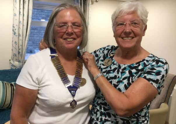 Jackie Atherton, new president of Bolsover Inner Wheel, receives the chain of office from her predecessor Pam McConnell.