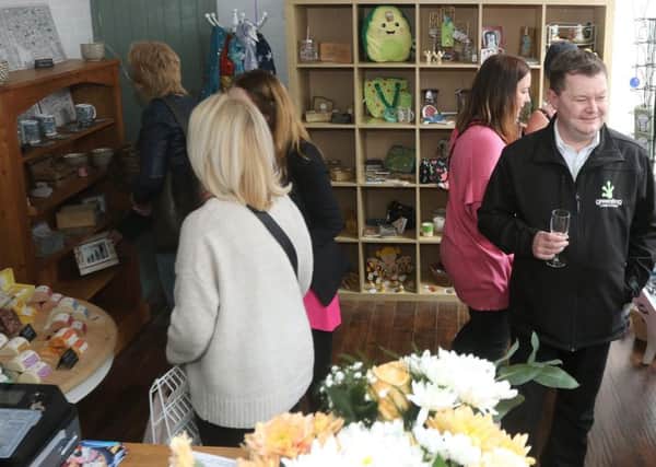Guests look round the newly opened shop