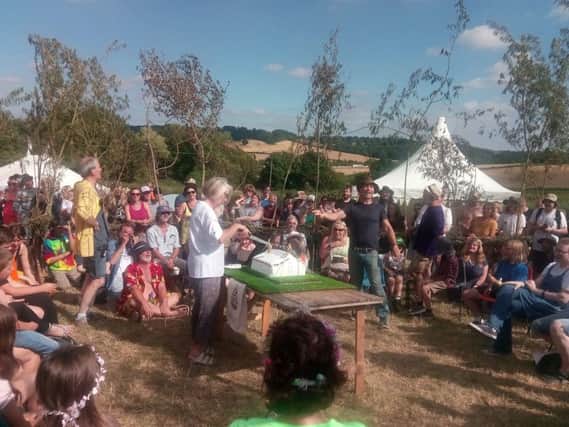Ann Syrett cuts the celebration cake at Stainsby Festival's 50th celebration.