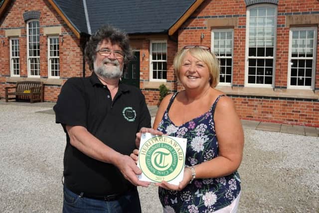 Mike Coupe, right, the secretary of the Tibshelf Local History and Civic Society, presents a Heritage Award plaque to Lorraine Hill for work done of Station Cottage, the former Tibshelf and Newton Railway Station.